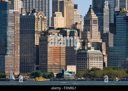 Huge skyscrapers waterfront from Battery Park and Pier A. Pier A in Battery Park is a building built in 1886 by the Department o Stock Photo
