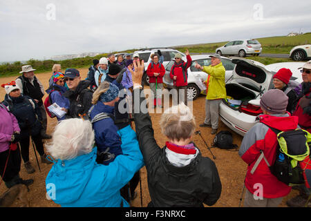 Isle of wight Walking Festival. 2015. people gathering at the start of the War Horse Walk in car park at Brook lady stroking a walkers dog Ramblers walkers walk leader asking who is from the island Stock Photo