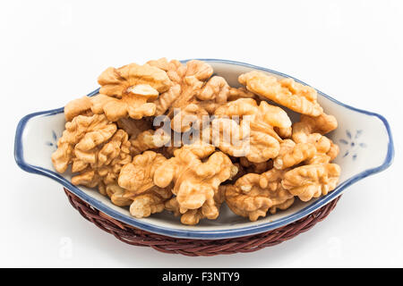 Kernels of ripe walnuts  in porcelain bowl. Stock Photo