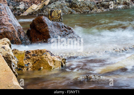 Splash waves hit rocks with the beautiful sunlight and sky Stock Photo ...