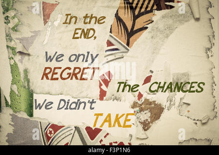 In The End, We Only Regret The Chances We Didn't Take - Inspirational message written on vintage grunge background with Old Torn Posters. Motivational concept image Stock Photo