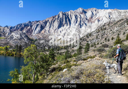 Hiker and dog on loop trail at Convict Lake near Mammoth Lakes in the Eastern Sierra Stock Photo