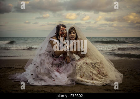 Sitges, Catalonia, Spain. 10th Oct, 2015. Zombie brides pose for a photo at the beach in front of the Sitges Zombie Walk 2015 © Matthias Oesterle/ZUMA Wire/Alamy Live News Stock Photo