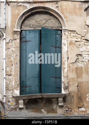 VENICE, ITALY - MAY 05, 2015:  Old wooden shutters on a window in a stone building Stock Photo