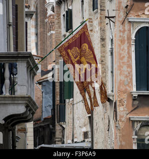 VENICE, ITALY - MAY 05, 2015:  Winged Lion ( St Mark's Lion) Banner Flag in Venice Stock Photo