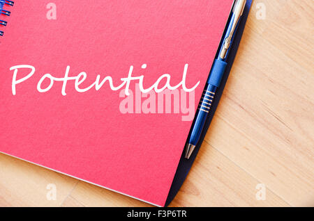 Notepad and pen on wooden background and text concept Stock Photo
