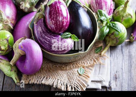 Eggplants of different color and variety on the table Stock Photo