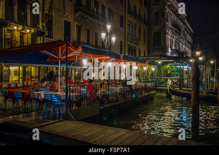 VENICE, ITALY - MAY 05, 2015: Restaurant Bar by the side of canal in Venice at night Stock Photo