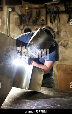 Welder welding sheet metal in a workshop Stock Photo