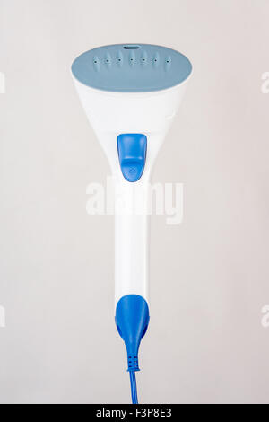 Image hand domestic garment steamer in phases, isolated on a light background Stock Photo