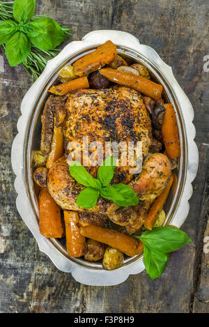 Roast chicken on rustic wooden table - top view Stock Photo