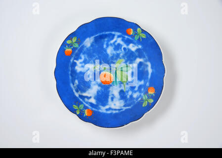 empty blue plate with strawberries on white background Stock Photo