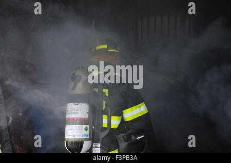 Firefighters with protective equipment in a smoke filled room