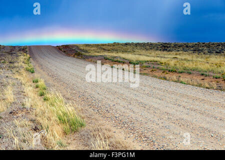 Rainbow over dirt road off highway 789 near Creston Junction; south central Wyoming; USA Stock Photo