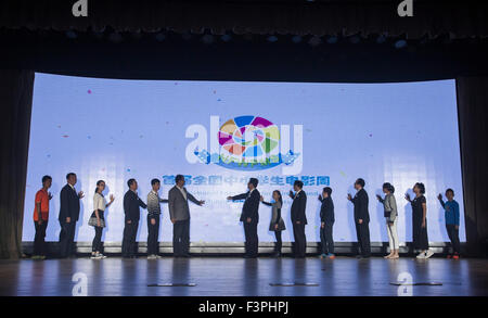 Beijing, China. 11th Oct, 2015. Guests and jury members jointly launch the 1st National Film Week for Primary and Middle School Students in Beijing, capital of China, Oct. 11, 2015. The 1st National Film Week for Primary and Middle School Students, which is themed with 70th anniversary of the victory of Chinese People's War of Resistance against Japanese Aggression and World War II, kicked off in Beijing 101 Middle School on Sunday. © Shen Bohan/Xinhua/Alamy Live News Stock Photo