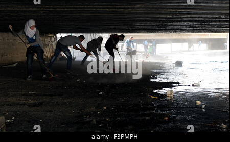 (151011)-- DAMASCUS, Oct. 11, 2015(Xinhua)-- Young Syrians clean an aqueduct connecting Barada River in Damascus, capital of Syria, on Oct. 11, 2015. Around 100 young Syrians on Sunday participated in a campaign to clean the aqueduct. Since the upstream of Barada River has been controlled by opposition militants in the past years, the water supply via the aqueduct to Damascus decreased while trashes appeared more in the aqueduct, defacing the city of Damascus. (Xinhua/Zhang Naijie)(azp) Stock Photo