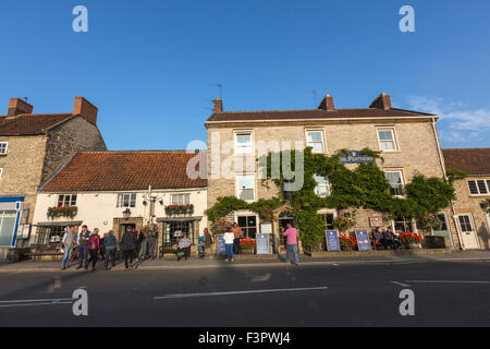 People drinking outside pubs in Helmsley Market Place,  Helmsley, North Yorkshire, England, United Kingdom Stock Photo