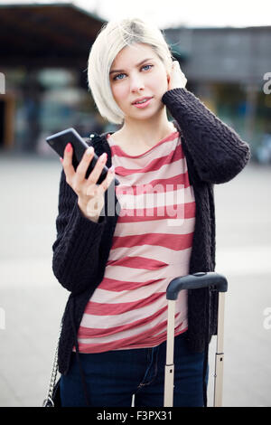 Woman using phone when traveling with public transport Stock Photo