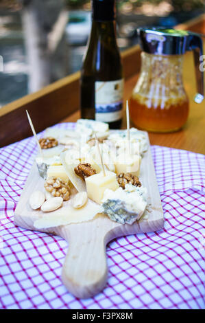 Still life with bottle of wine and cheese outdoor Stock Photo