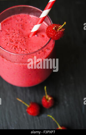 Glass with rasberry smoothie on the table, Selective focus Stock Photo