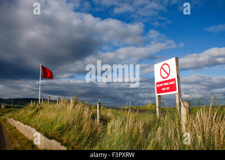 Keep out sign and red warning flag at military firing range, Magilligan Point, Northern Ireland Stock Photo