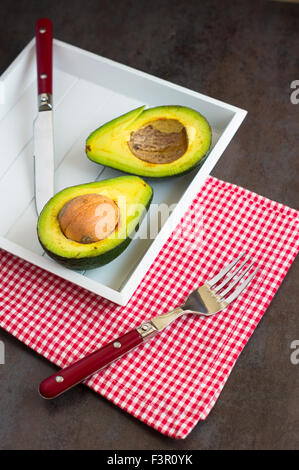 avocado on a dark wood background. tinting. selective focus Stock Photo