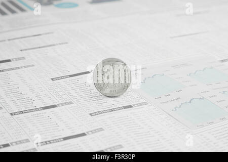 South African Rand Coin on a News paper Stock market financial page showing stocks and shares Stock Photo