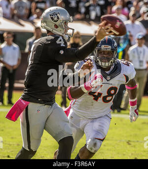 Denver Broncos linebacker Al Wilson (L) upends New England wide