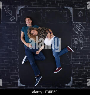 Young couple feeling joyful in bed. Image taken from above. Stock Photo