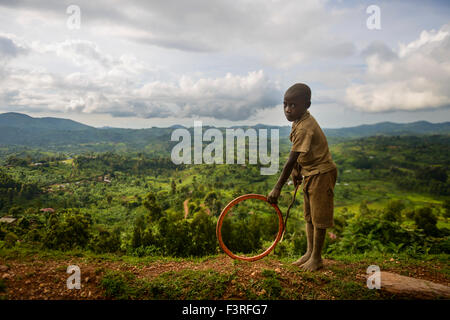 Kid playing with a hoop, Uganda, Africa Stock Photo