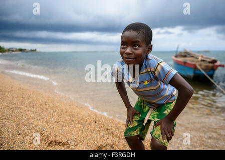 Boy fishing on lake shore Stock Photo - Alamy