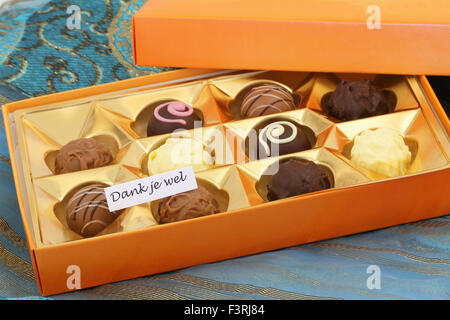 Dank je wel (which means thank you in Dutch) with box of chocolates and pralines Stock Photo