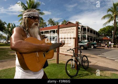 Hippye Playing guitar near the emblematic and ancient building Court and Prison of Lahaina. Maui. Hawaii. From its opening fanfa Stock Photo