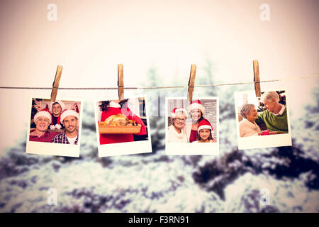 Composite image of clothes peg on line with instant photos Stock Photo