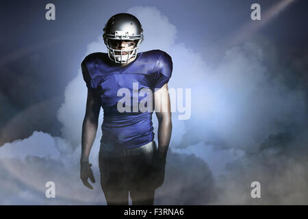 Composite image of american football player in red jersey looking down ...