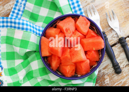 Bowl of fresh watermelon cubes on green and white checkered cloth Stock Photo