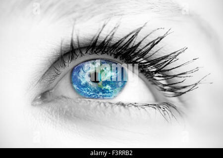 Composite image of blue eye on grey face Stock Photo