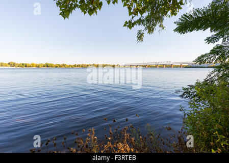 The Dnieper river and the Kiev's Petrovskyi railway bridge. It was built in 1929. During the Great Patriotic War it was ruined a Stock Photo