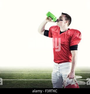 Composite image of american football player drinking Stock Photo