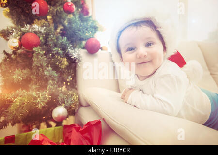 Cute baby boy on couch at christmas Stock Photo