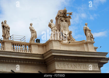 Statues on the colonnades in St Peter's Square, with inscription of Pope Alexander VII. Stock Photo