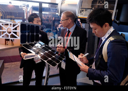 Jerusalem, Israel. 12th October, 2015. Visitors from Japan speaking with representative of Israeli Rafael Advanced Defense Systems company at the IAC International Astronautical Congress in Jerusalem, Israel on 12 October 2015. Israel’s space sector has significantly developed and expanded recent years in diverse areas of interest. Israeli President Reuven Rivlin, along with representatives of Google and Spacell an Israeli space engineering company, announced last week that Israel plans to land a private spacecraft on the moon before the end of 2017. Credit:  Eddie Gerald/Alamy Live News Stock Photo