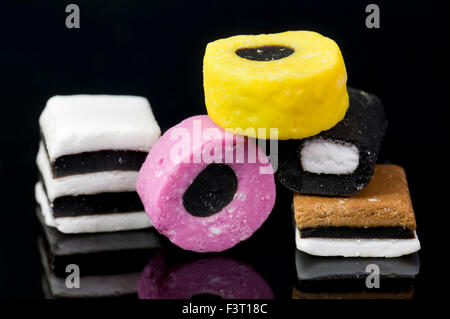 Close up of liquorice allsorts on black reflective background Stock Photo