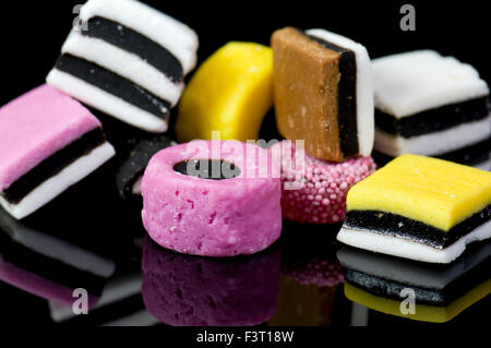 Close up of liquorice allsorts on black reflective background Stock Photo