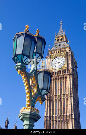 London, Westminster  An ornate lamp standard on Westminster Bridge, with the Queen Elizabeth tower in the background Stock Photo