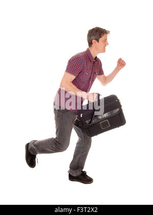 A young man in jeans holding his briefcase and running, isolated for white background. Stock Photo