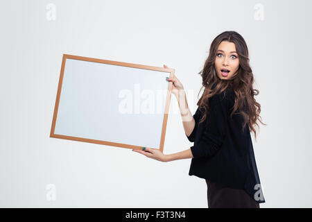 Portrait of attractive young girl showing blank board isolated on a white background Stock Photo