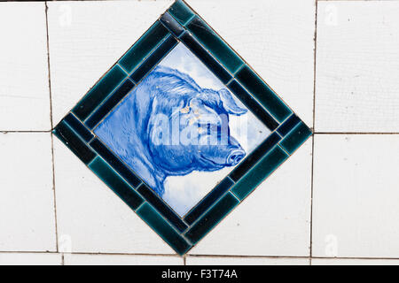 old butchers shop tiling with image of a pig Stock Photo