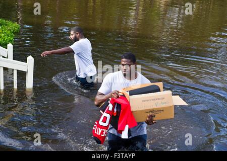 Pittsburgh Steelers football player Clifton Geathers helps remove possessions from his family home overwhelmed by floodwaters October 10, 2015 in Browns Ferry, South Carolina. Large parts of South Carolina suffered from record setting rains that flooded large portions of the state. Stock Photo