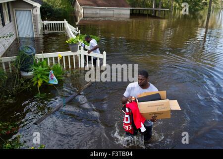 Pittsburgh Steelers football player Clifton Geathers helps remove possessions from his family home overwhelmed by floodwaters October 10, 2015 in Browns Ferry, South Carolina. Large parts of South Carolina suffered from record setting rains that flooded large portions of the state. Stock Photo